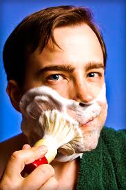 Foaming the face with shave brush wet shaving